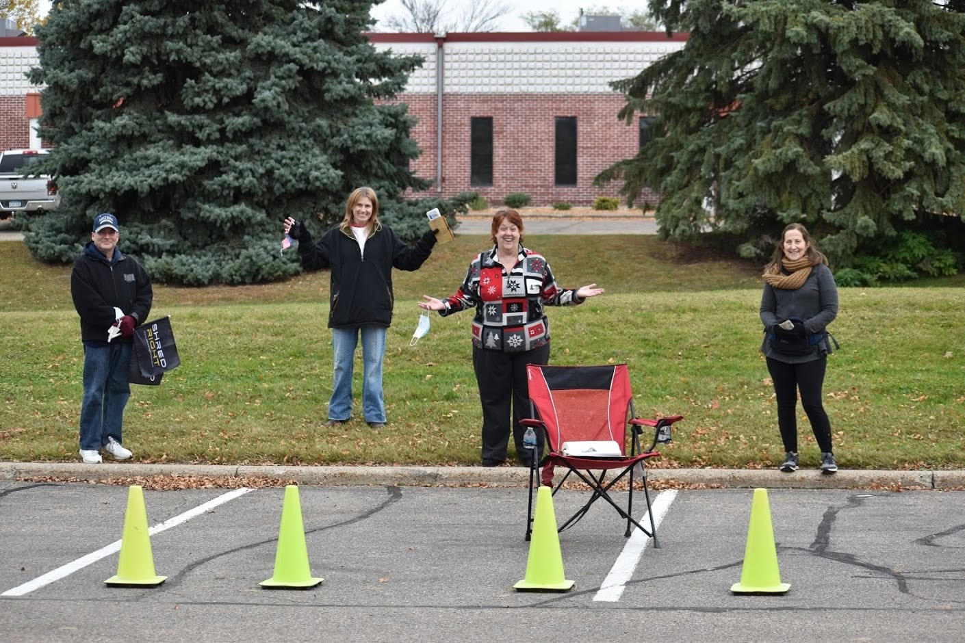 Four MNHTF volunteers socially distanced with traffic cones at Shred Right event